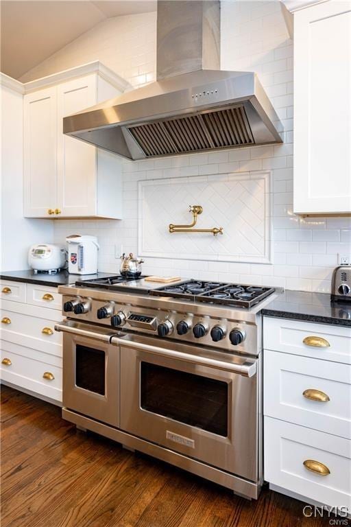 4500 W Lake Rd, Niles, NY 13152 - kitchen featuring wall chimney exhaust hood, double oven range, white cabinets, vaulted ceiling, and decorative backsplash
