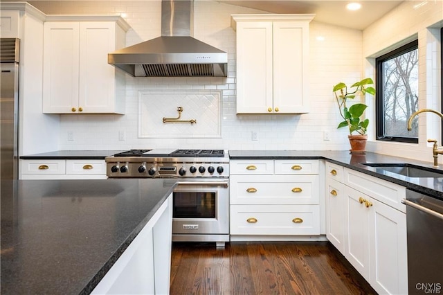 4500 W Lake Rd, Niles, NY 13152 - kitchen with wall chimney exhaust hood, appliances with stainless steel finishes, a sink, dark wood-style flooring, and white cabinets