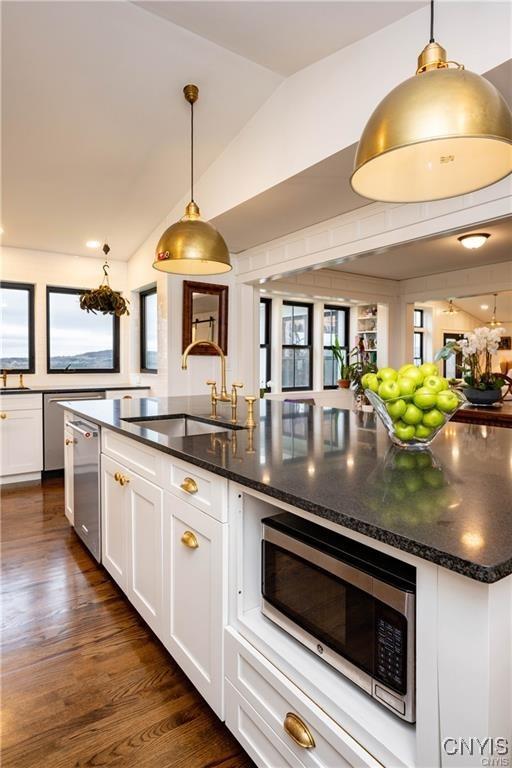 4500 W Lake Rd, Niles, NY 13152 - kitchen featuring appliances with stainless steel finishes, a sink, lofted ceiling, white cabinetry, and healthy amount of natural light