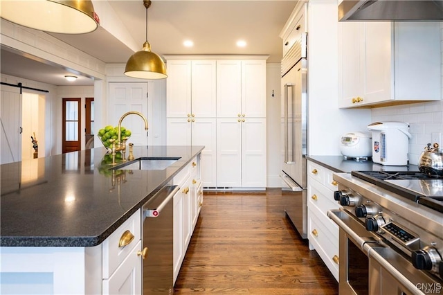 4500 W Lake Rd, Niles, NY 13152 - kitchen with a sink, high end appliances, a barn door, white cabinets, and decorative backsplash