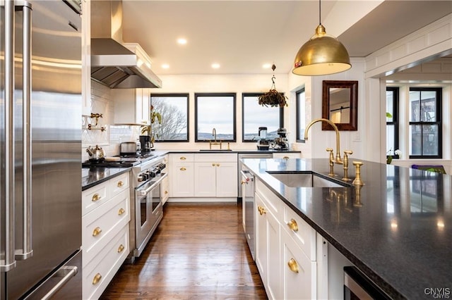 4500 W Lake Rd, Niles, NY 13152 - kitchen featuring high quality appliances, a sink, wall chimney exhaust hood, dark wood-style flooring, and recessed lighting