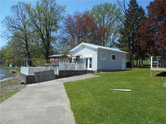 4700 W Lake Rd, Fleming, NY 13021 - view of front of home with a deck, a front yard, and french doors