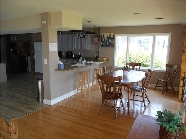 4700 W Lake Rd, Fleming, NY 13021 - dining area featuring hardwood / wood-style flooring, baseboards, and a fireplace