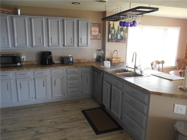 4700 W Lake Rd, Fleming, NY 13021 - kitchen featuring stainless steel microwave, a sink, dishwashing machine, a peninsula, and wood finished floors
