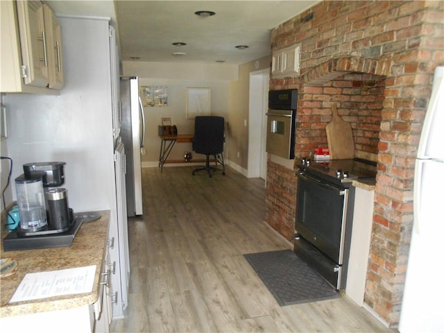 4700 W Lake Rd, Fleming, NY 13021 - kitchen featuring appliances with stainless steel finishes, light wood-style floors, light countertops, and baseboards