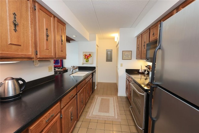 135 Cliffside Dr, South Bristol, NY 14424 - kitchen with stainless steel appliances, a sink, light tile patterned flooring, and brown cabinetry