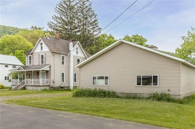 39 Middle St, Hancock, NY 13756 - view of side of property with covered porch, a lawn, and a chimney