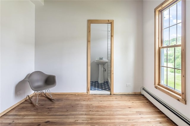 39 Middle St, Hancock, NY 13756 - sitting room featuring baseboard heating, wood finished floors, and baseboards