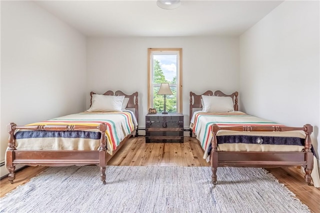 39 Middle St, Hancock, NY 13756 - bedroom with wood finished floors, baseboard heating, and baseboards