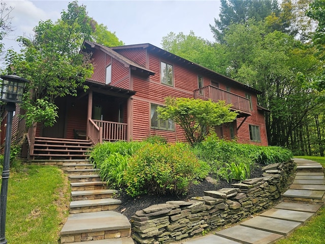 139 Pheasant Run Rd, Middlefield, NY 13326 - view of front facade with stairway, a porch, and a balcony