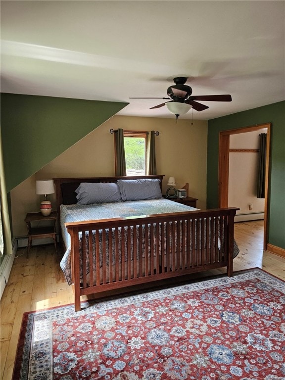 139 Pheasant Run Rd, Middlefield, NY 13326 - bedroom featuring light wood-style floors, a baseboard radiator, and a ceiling fan