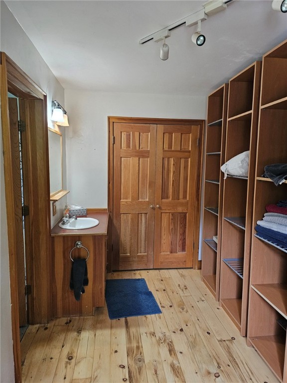 139 Pheasant Run Rd, Middlefield, NY 13326 - bathroom featuring hardwood / wood-style flooring, vanity, and track lighting