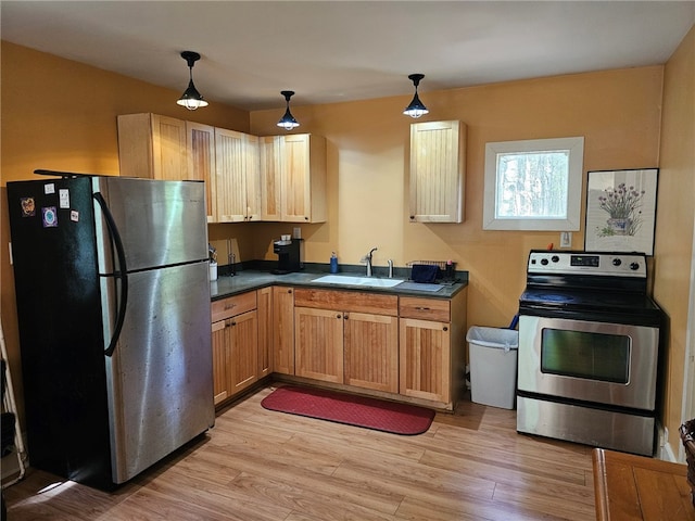 139 Pheasant Run Rd, Middlefield, NY 13326 - kitchen with stainless steel appliances, a sink, dark countertops, and light wood finished floors