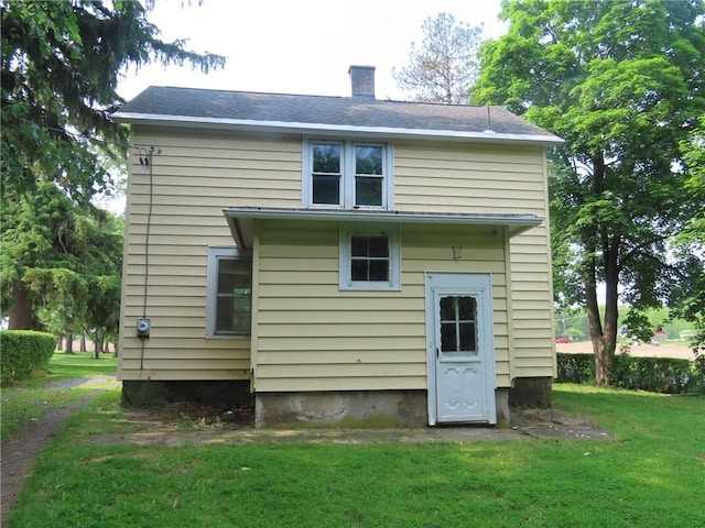 6018 Dunning Ave, Fleming, NY 13021 - rear view of house featuring a chimney and a lawn