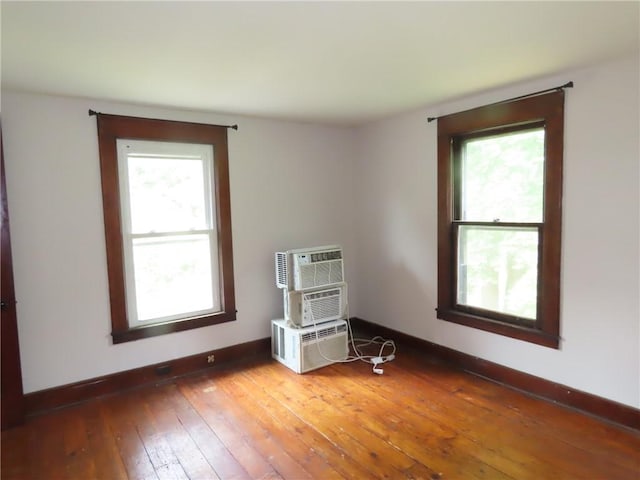 6018 Dunning Ave, Fleming, NY 13021 - unfurnished room featuring light wood-style flooring, baseboards, and an AC wall unit