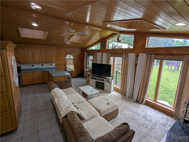 2976 Cataract St, Denmark, NY 13626 - living area with wooden ceiling, vaulted ceiling, ceiling fan, wooden walls, and light tile patterned floors