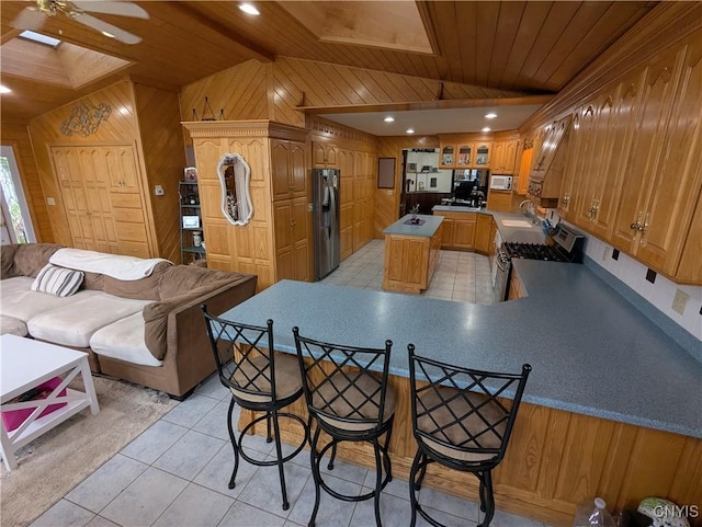 2976 Cataract St, Denmark, NY 13626 - kitchen featuring wooden walls, lofted ceiling, stainless steel appliances, wood ceiling, and a sink