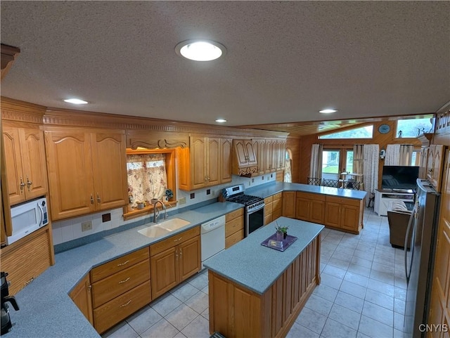 2976 Cataract St, Denmark, NY 13626 - kitchen featuring white appliances, a sink, a textured ceiling, a peninsula, and light tile patterned floors