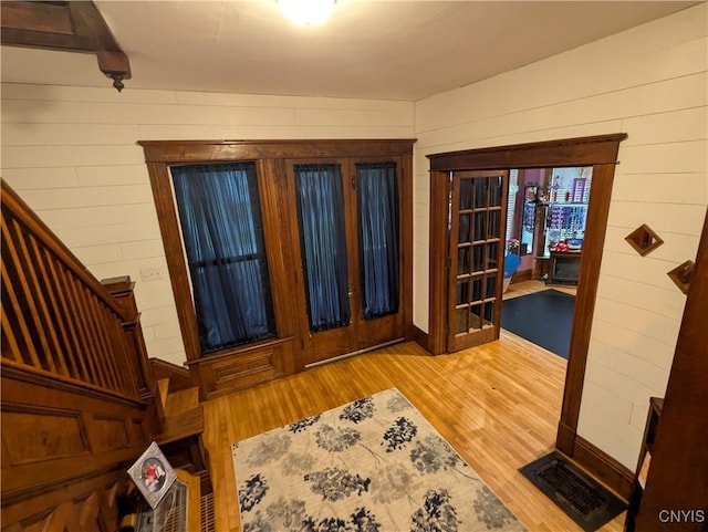 2976 Cataract St, Denmark, NY 13626 - foyer with wood finished floors, wood walls, and stairs
