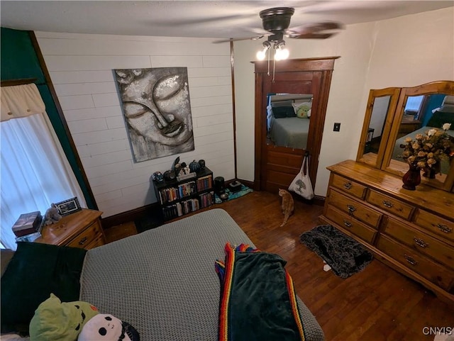 2976 Cataract St, Denmark, NY 13626 - bedroom with wood finished floors, ceiling fan, baseboards, and wooden walls