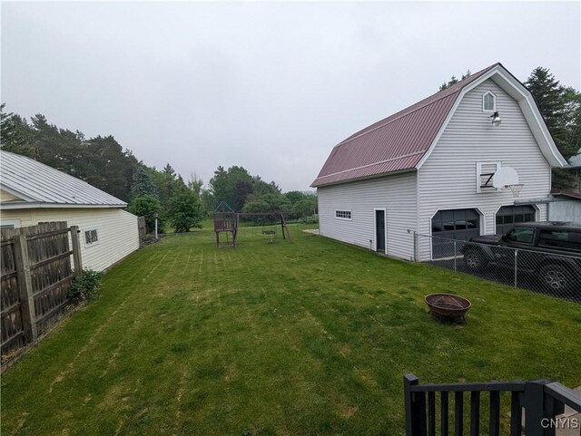 2976 Cataract St, Denmark, NY 13626 - view of yard with a fire pit, a barn, an outdoor structure, and a playground