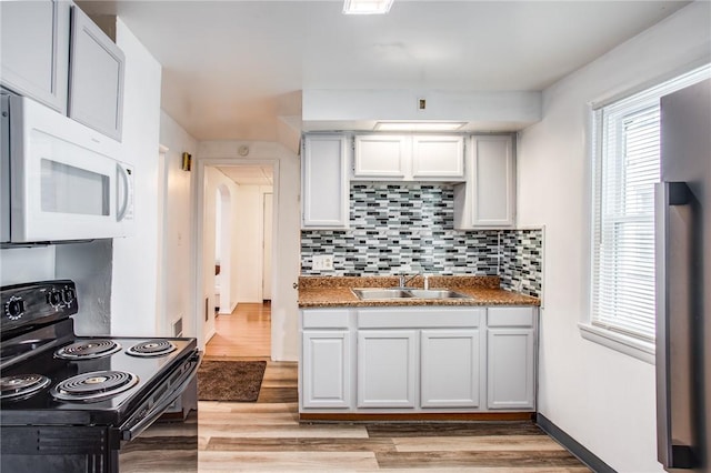 239 Weyl, Rochester, NY 14621 - kitchen with white microwave, electric range, a sink, decorative backsplash, and light wood-type flooring