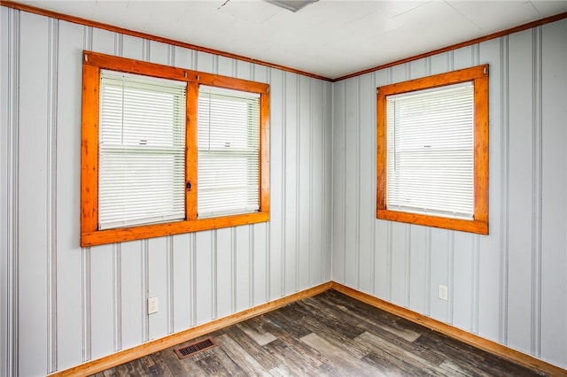 239 Weyl, Rochester, NY 14621 - unfurnished room featuring dark wood-style flooring, crown molding, baseboards, and a decorative wall