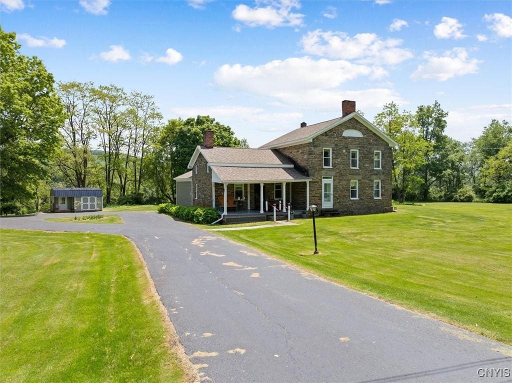 8796 State Highway 12, Sherburne, NY 13460 - view of front of property with a front lawn, covered porch, a chimney, and stone siding