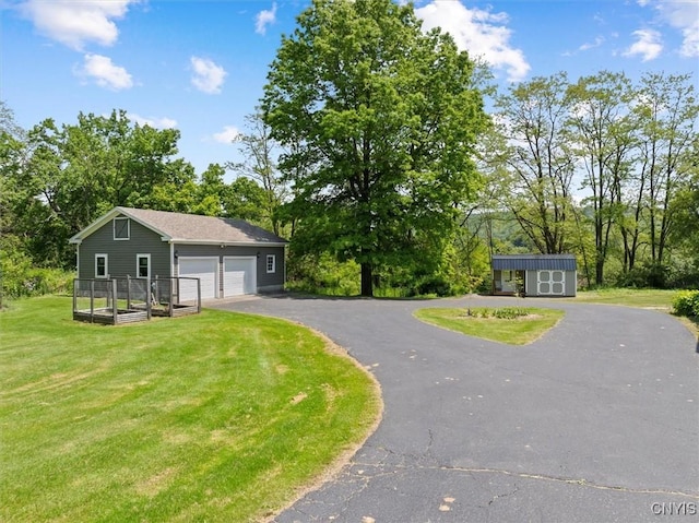 8796 State Highway 12, Sherburne, NY 13460 - view of front of house featuring a front yard, asphalt driveway, a garage, and view of scattered trees