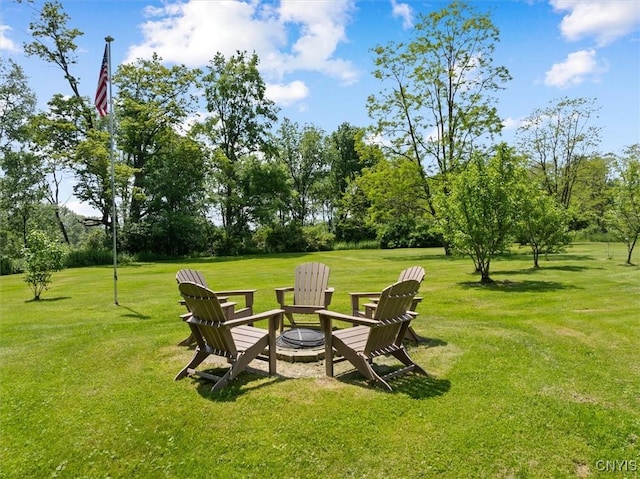 8796 State Highway 12, Sherburne, NY 13460 - view of grassy yard featuring an outdoor fire pit and view of scattered trees