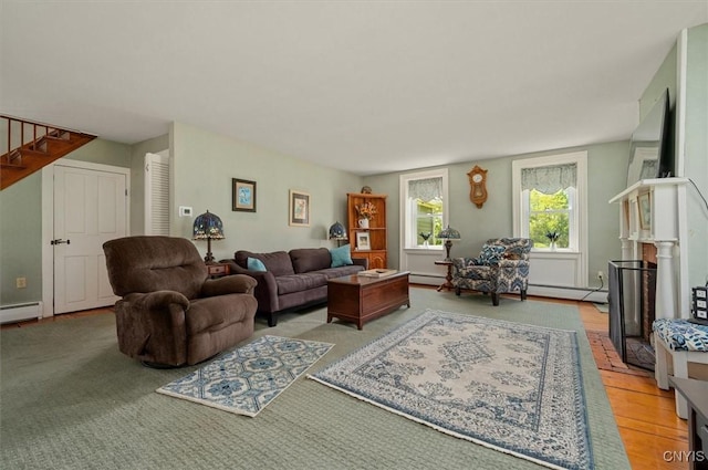 8796 State Highway 12, Sherburne, NY 13460 - living room featuring a baseboard heating unit and stairs