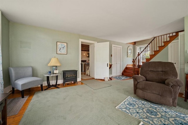 8796 State Highway 12, Sherburne, NY 13460 - living room with a wood stove, stairway, and light wood-style flooring