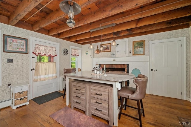 8796 State Highway 12, Sherburne, NY 13460 - kitchen featuring dark wood-style flooring, a breakfast bar, wallpapered walls, a fireplace, and wood ceiling with exposed beams