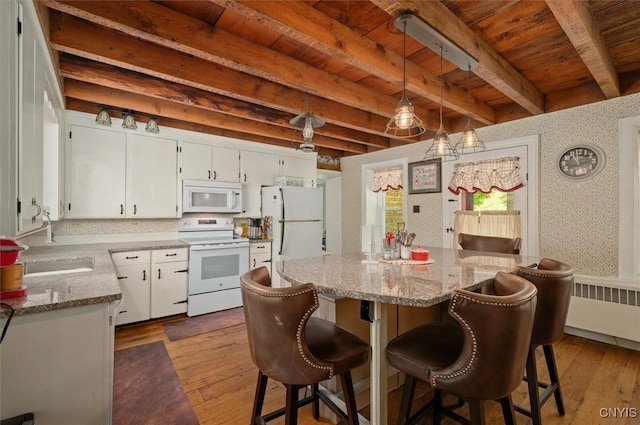 8796 State Highway 12, Sherburne, NY 13460 - kitchen with white appliances, dark wood-style floors, radiator, white cabinetry, and wood ceiling with exposed beams