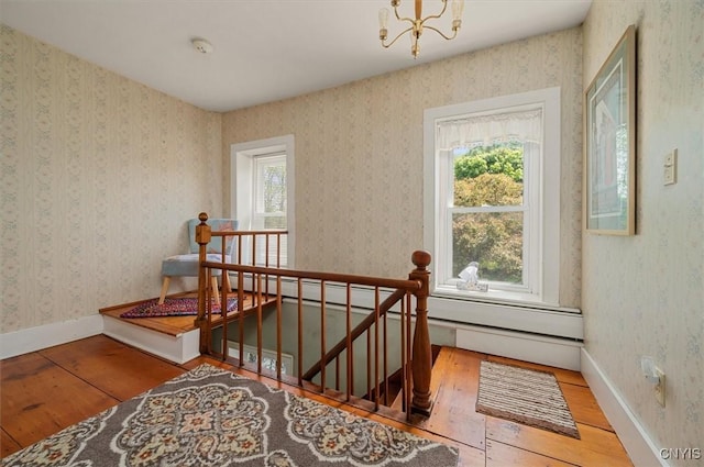 8796 State Highway 12, Sherburne, NY 13460 - stairway with wood-type flooring, a chandelier, and baseboards