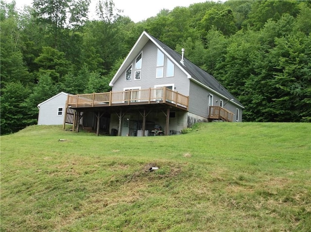 24780 State Highway 206, Colchester, NY 13755 - rear view of house featuring a deck, a wooded view, and a lawn