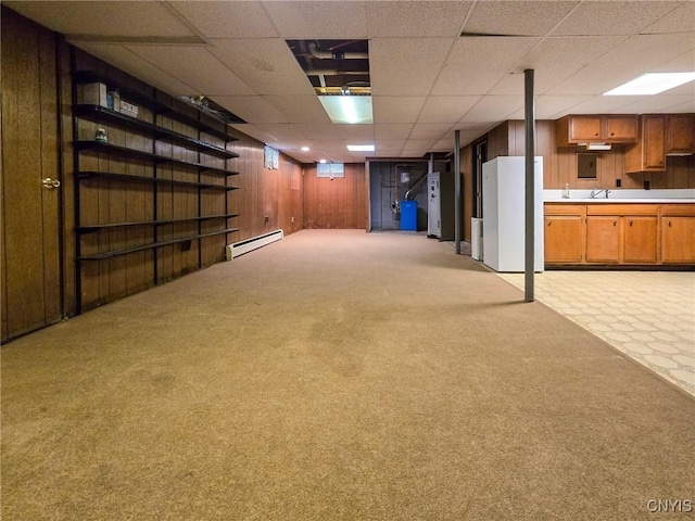 3636 Kennedy Rd, Lafayette, NY 13084 - finished below grade area with light carpet, a baseboard radiator, wood walls, a paneled ceiling, and freestanding refrigerator