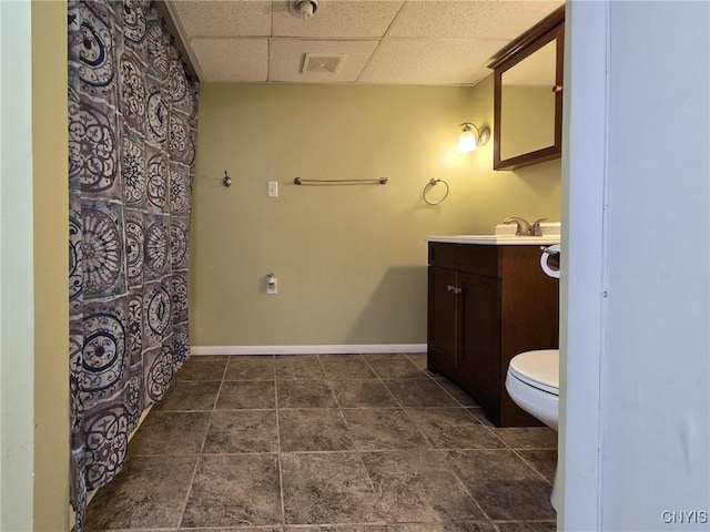 3636 Kennedy Rd, Lafayette, NY 13084 - bathroom featuring a paneled ceiling, vanity, toilet, and baseboards