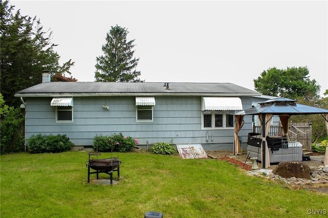 3636 Kennedy Rd, Lafayette, NY 13084 - back of house featuring a fire pit, a gazebo, a lawn, and a chimney