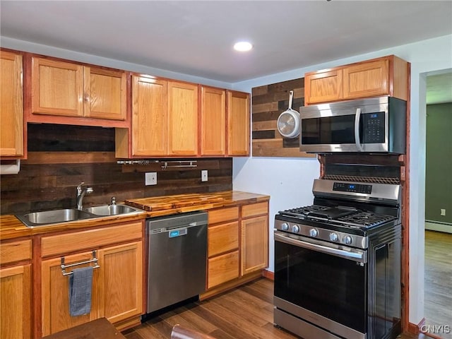 3636 Kennedy Rd, Lafayette, NY 13084 - kitchen with stainless steel appliances, a sink, dark wood finished floors, wooden counters, and tasteful backsplash