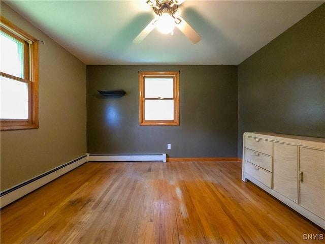 3636 Kennedy Rd, Lafayette, NY 13084 - spare room featuring ceiling fan, light wood-style floors, a baseboard radiator, and baseboards
