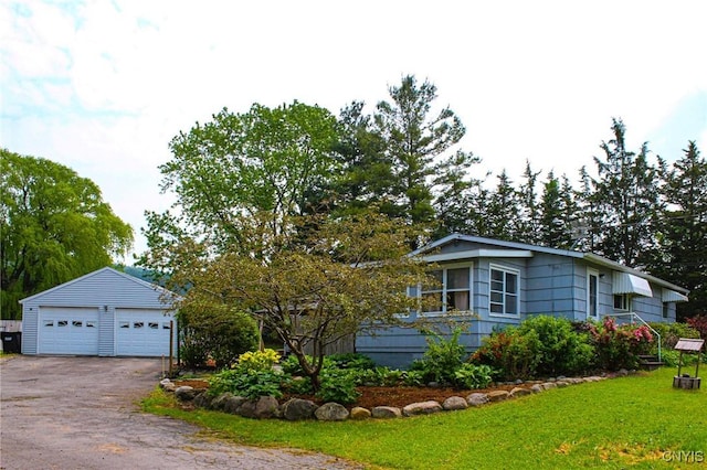 3636 Kennedy Rd, Lafayette, NY 13084 - view of front of home with a detached garage, a front yard, and an outbuilding