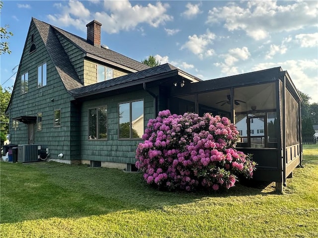 966 W Church St, Elmira, NY 14905 - view of home's exterior with a ceiling fan, a chimney, a sunroom, and a yard