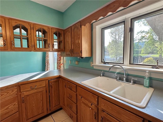 966 W Church St, Elmira, NY 14905 - kitchen with a sink, brown cabinetry, plenty of natural light, and light countertops