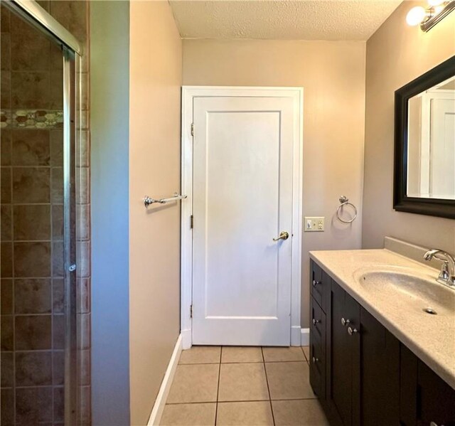 966 W Church St, Elmira, NY 14905 - full bathroom with vanity, tile patterned flooring, tiled shower, a textured ceiling, and baseboards
