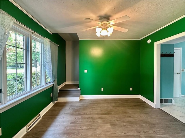 966 W Church St, Elmira, NY 14905 - empty room with a textured ceiling, ceiling fan, wood finished floors, crown molding, and baseboards