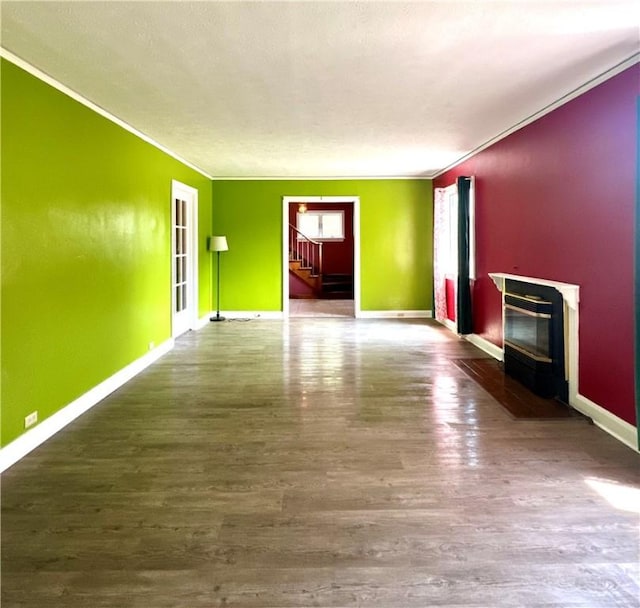 966 W Church St, Elmira, NY 14905 - unfurnished living room with stairs, a fireplace with flush hearth, baseboards, wood finished floors, and crown molding