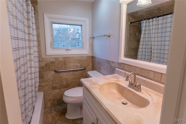 4 Division St, Van Buren, NY 13027 - full bathroom with tile walls, vanity, toilet, shower / tub combo with curtain, and wainscoting