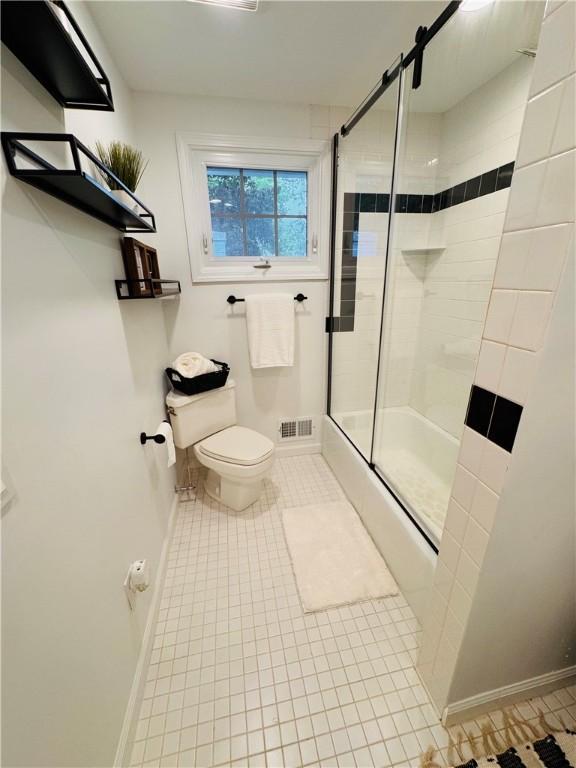 11 Laureldale Dr, Pittsford, NY 14534 - full bath with toilet, a shower with shower door, tile patterned flooring, and baseboards