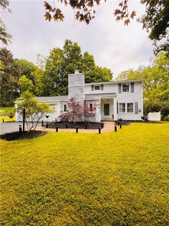 11 Laureldale Dr, Pittsford, NY 14534 - rear view of house featuring a yard, a chimney, and driveway